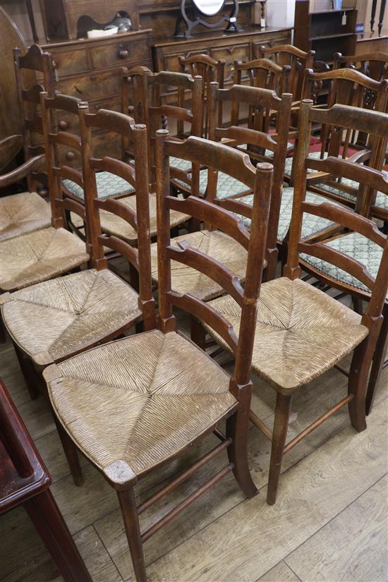 A set of six oak ladderback rush seated chairs and similar open armchair